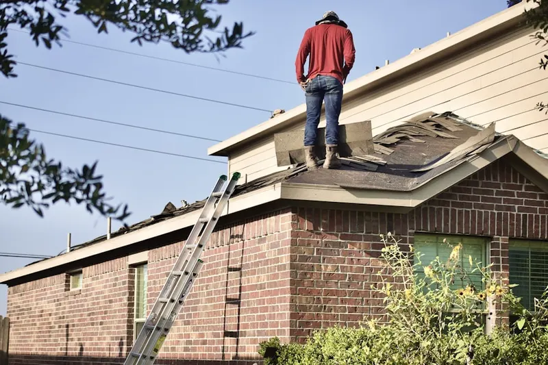 Professional roofer working on a residential roof in Burnham Woods